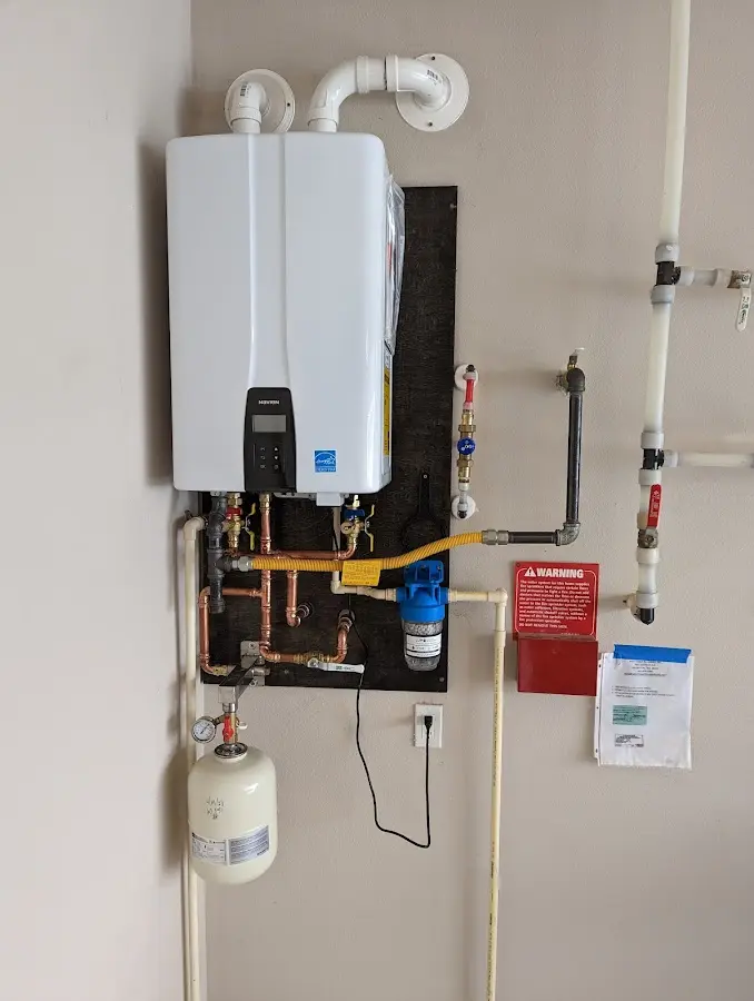 Professional plumber installing copper piping in a Longmeadow home